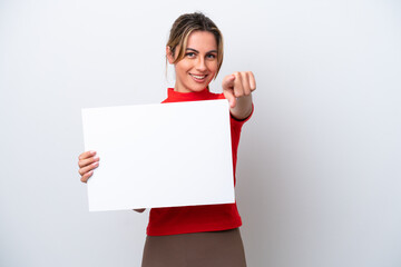 Young caucasian woman isolated on white background holding an empty placard and pointing to the...
