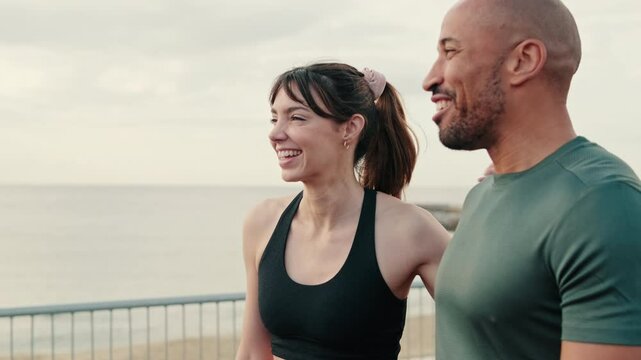 Close-up of happy young sporty couple have dialog, two athletes enjoy conversation, walking and laughing