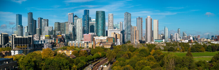 Fototapeta premium Panoramic aerial image of Canary wharf skyline from Mudchute park in Autumn. 