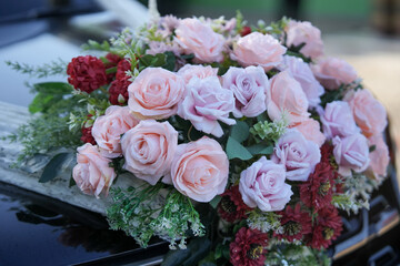 Elegant floral arrangement featuring pink and purple roses, delicate bouquet with mixed blooms, sophisticated flower composition with varied textures.
