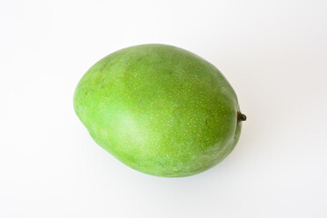 a whole mango that is green isolated on white top view