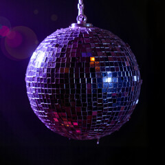 Obraz premium Purple disco ball reflecting colorful lights against dark background