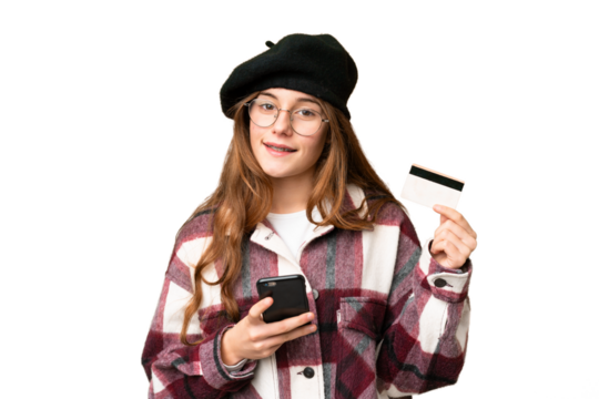Teenager girl over isolated chroma key background buying with the mobile with a credit card