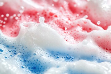 Obraz premium Close-up shot of foamy surface featuring red, white and blue bubbles