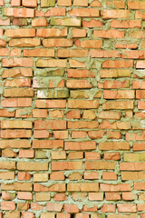 brick wall facade texture texture background. A textured background of decayed old red and white bricks in an exterior uneven wall of a house with dirty whitewashed worn plaster. Brick wall