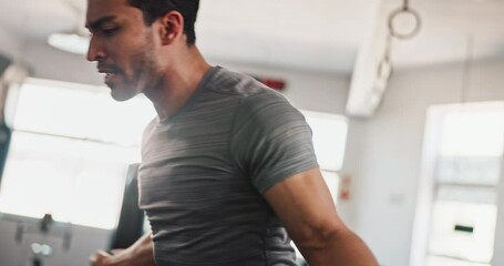 Exercise, skipping rope or man jumping in gym with fitness for health, training or cardio activity in challenge. Action, agility movement or motion of athlete with wellness, body workout or energy