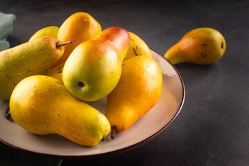ripe green pears on dark background.