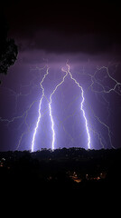 Lightning and thunderstorms in the night sky. Silhouettes of large lightning bolts against a dark background.