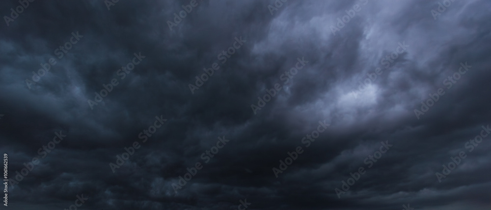 Poster the dark sky with heavy clouds converging and a violent storm before the rain.bad or moody weather s