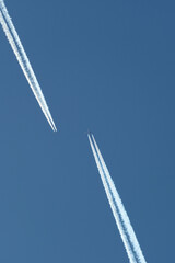 Airplane trails in the blue sky, contrails.