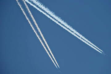 Airplane trails in the blue sky, contrails.