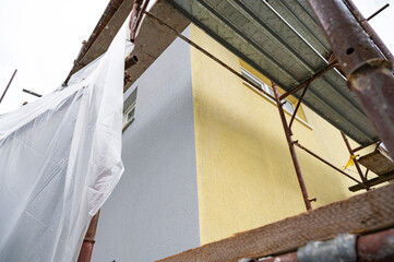 Two tone house facade during renovation