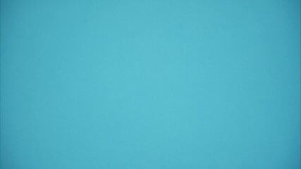 An open blank diary closes and rolls away on blue background. Stop motion