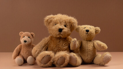 Soft toy bears on a beige background.