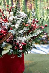 Christmas bouquet of pine needles with cones on green background with bokeh