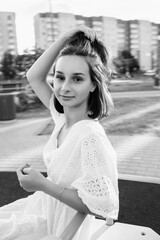 Portrait of a beautiful young girl in an urban environment. Black and white photo.