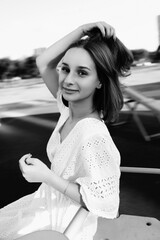 Portrait of a beautiful young girl in an urban environment. Black and white photo.