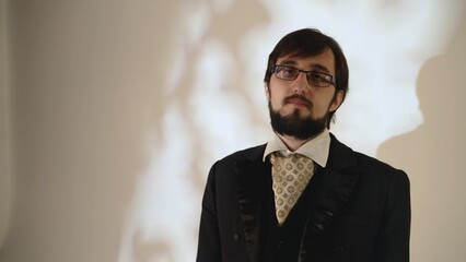 Groom wearing elegant suit and cravat posing for photo shoot