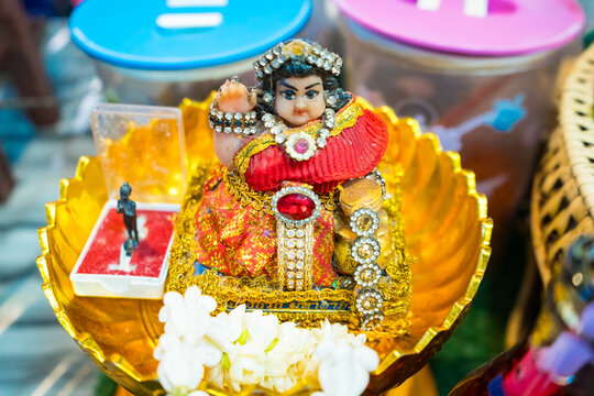 Nonthaburi, Thailand - July, 11, 2024 - Charming Nang Kwak Statue in a Gold Tray at a Local Market Eatery at Nonthaburi, Thailand