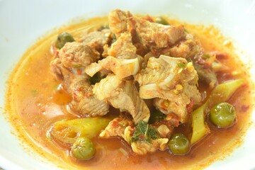 spicy fried pork soft bone with curry and eggplant on plate 