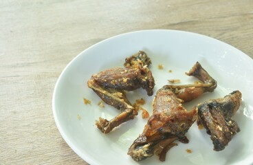 salty deep fried mountain frog leg with crispy garlic Thai food on plate