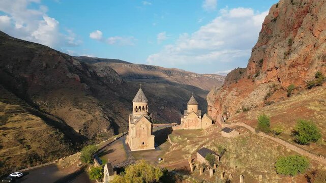 Aerial panning left view Noravank monastery complex, 13th-century Armenian monastery. Holy Mother of God church.Noravank at Amaghu. Red cliffs gorge by Arani village. Tourist destination in Armenia