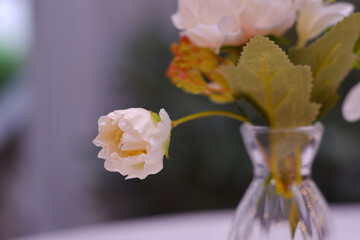 White plastic flowers in a clear vase