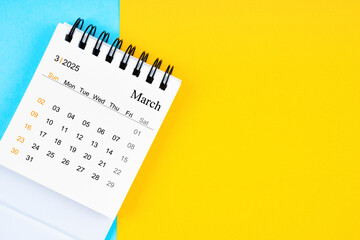 March 2025, Monthly desk calendar for 2025 year on yellow and blue background.