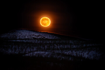 Full moon through Swedish hills