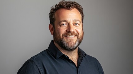 Smiling Man with Beard Against Neutral Background