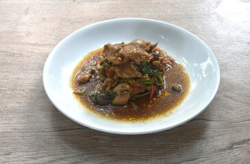 spicy chili stir-fried chicken meat and gizzard couple liver with basil leaf on plate