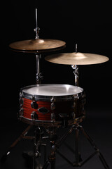Fototapeta premium Different drums on a black background, percussion musical instruments