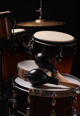 Different drums on a black background, percussion musical instruments