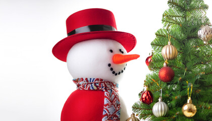 Fototapeta premium A snowman next to a Christmas tree decorated with Christmas ornaments background concept isolated white