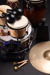 Obraz premium Different drums on a black background, percussion musical instruments