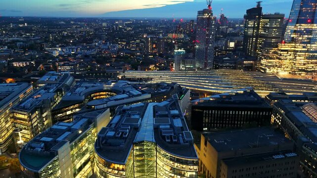 Aerial video of illuminated London skyline on early evening. 