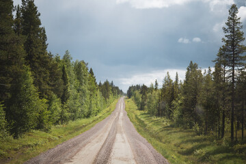 the view of a gravel road in the wilderness of norway