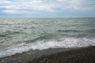 Black Sea on the Sochi coast and a pebble beach on a sunny day with clouds, Sochi, Krasnodar Territory, Russia