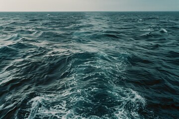 Fototapeta premium Endless waves create a vast, undulating pattern on the open ocean, evoking a sense of adventure and infinite possibility.