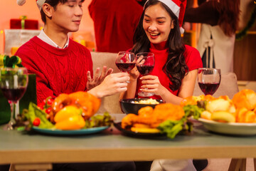 An upbeat New Year’s Eve celebration with Asian friends, family, colleagues, blending work and holiday vibes.while table brims with champagne, wine, gift boxes, delicious foods grilled chicken