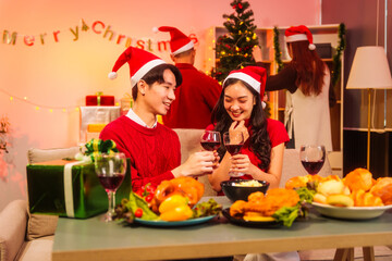 An upbeat New Year’s Eve celebration with Asian friends, family, colleagues, blending work and holiday vibes.while table brims with champagne, wine, gift boxes, delicious foods grilled chicken