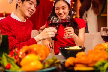 An upbeat New Year’s Eve celebration with Asian friends, family, colleagues, blending work and holiday vibes.while table brims with champagne, wine, gift boxes, delicious foods grilled chicken