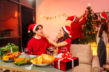 An upbeat New Year’s Eve celebration with Asian friends, family, colleagues, blending work and holiday vibes.while table brims with champagne, wine, gift boxes, delicious foods grilled chicken