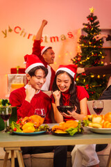 An upbeat New Year’s Eve celebration with Asian friends, family, colleagues, blending work and holiday vibes.while table brims with champagne, wine, gift boxes, delicious foods grilled chicken