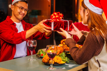 An upbeat New Year’s Eve celebration with Asian friends, family, colleagues, blending work and holiday vibes.while table brims with champagne, wine, gift boxes, delicious foods grilled chicken