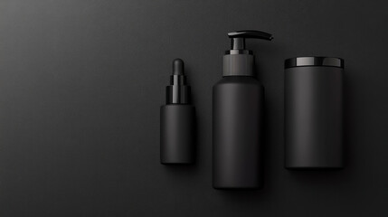 Fototapeta premium Sleek black cosmetic containers arranged on dark surface, showcasing modern design and elegance. Perfect for beauty and skincare branding