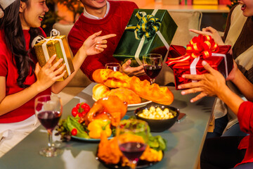 An upbeat New Year’s Eve celebration with Asian friends, family, colleagues, blending work and holiday vibes.while table brims with champagne, wine, gift boxes, delicious foods grilled chicken