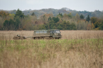 British army bae systems, Puch, Daimler, Pinzgauer High-Mobility All-Terrain 6x6 vehicle towing a 105mm Light Artillery Gun on a military exercise © Martin
