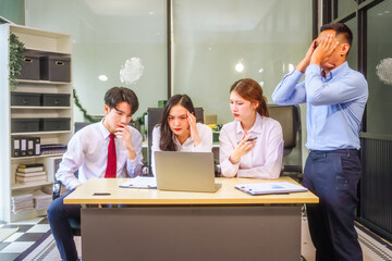 Two men and two women, including boss and employees, discuss recent mistake. Expressions of...