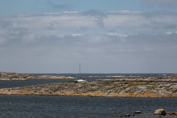 scissor islands off sm&ouml;gen in sweden, with bright sunshine and small white clouds